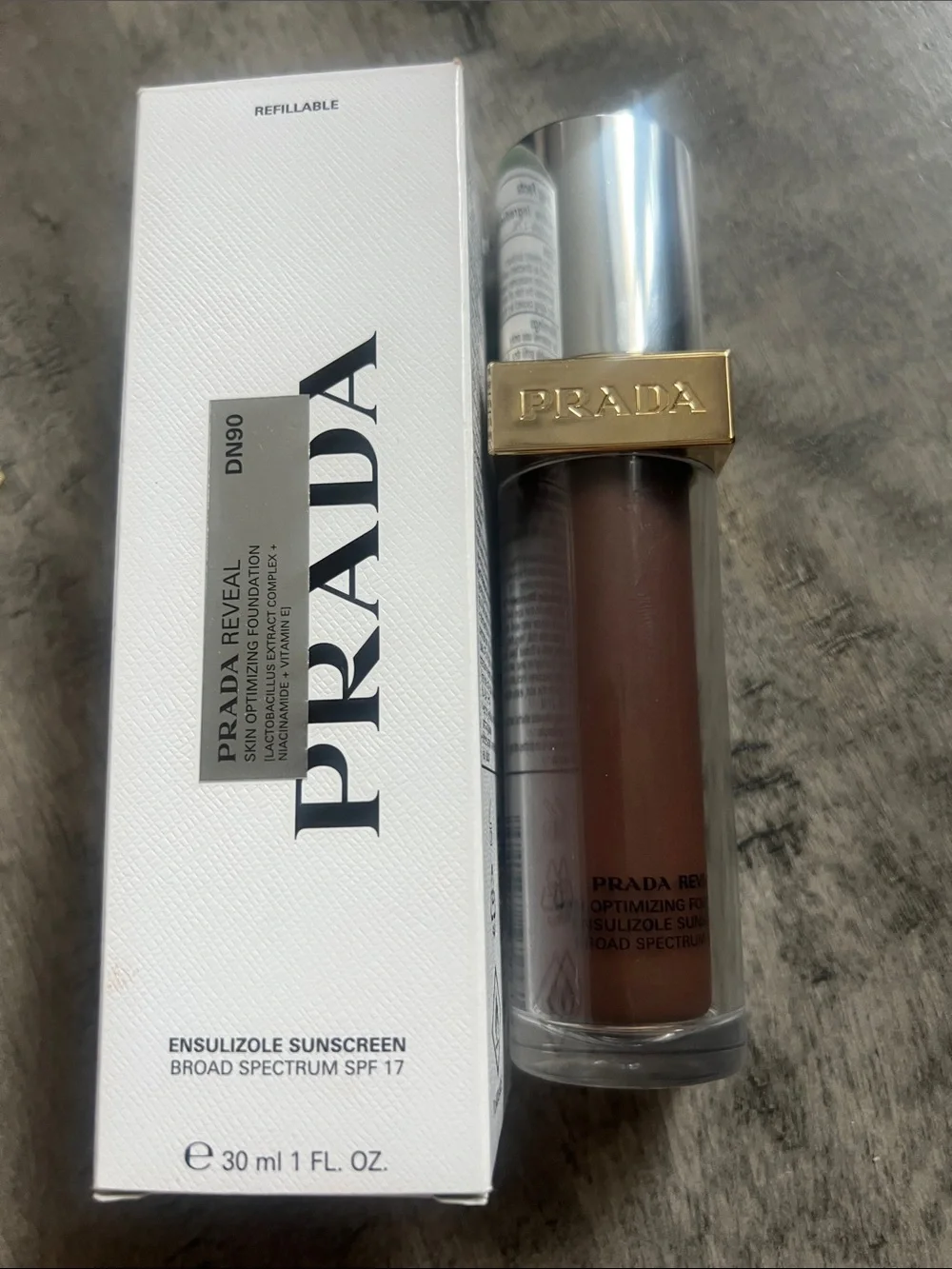 Prada Reveal Ensulizole Sunscreen SPF 17 in White and Gold Accents
